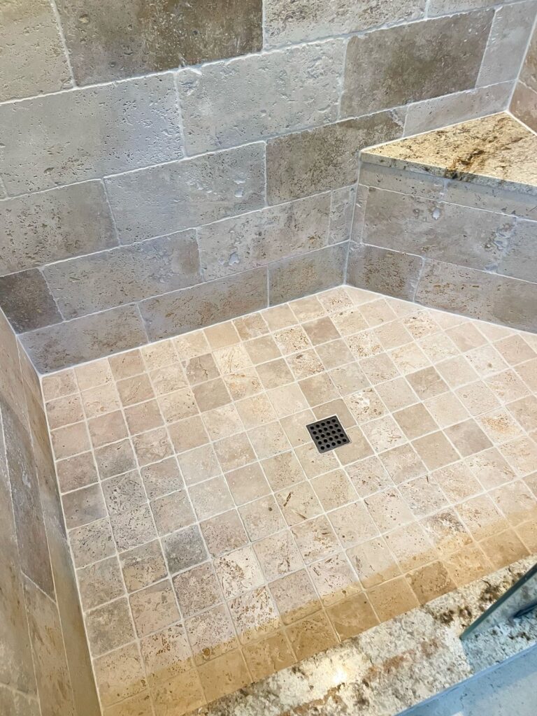The same shower after cleaning, new corner seams and color-sealed grout lines