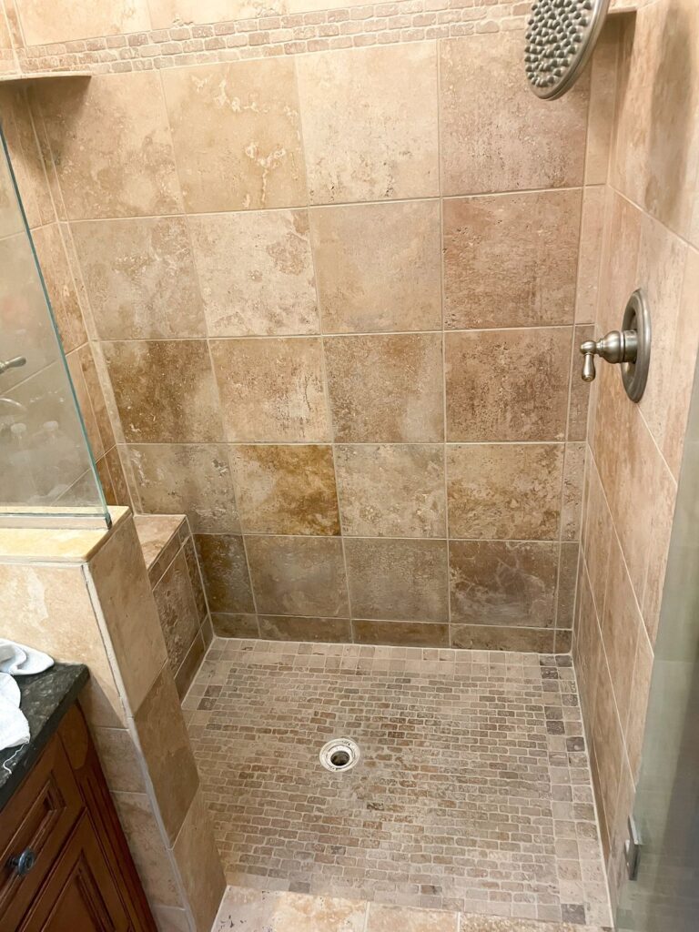 Tiled shower after full cleaning, epoxy corner seams and color sealing
