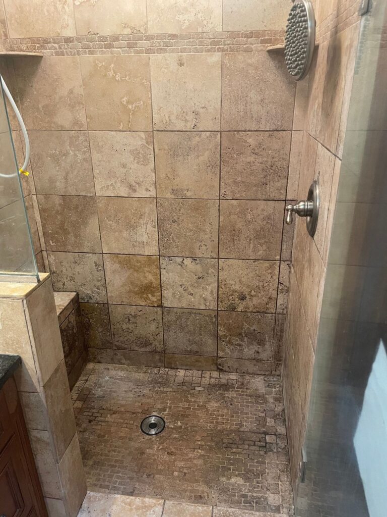 Tiled shower before cleaning and sealing with dingy grout