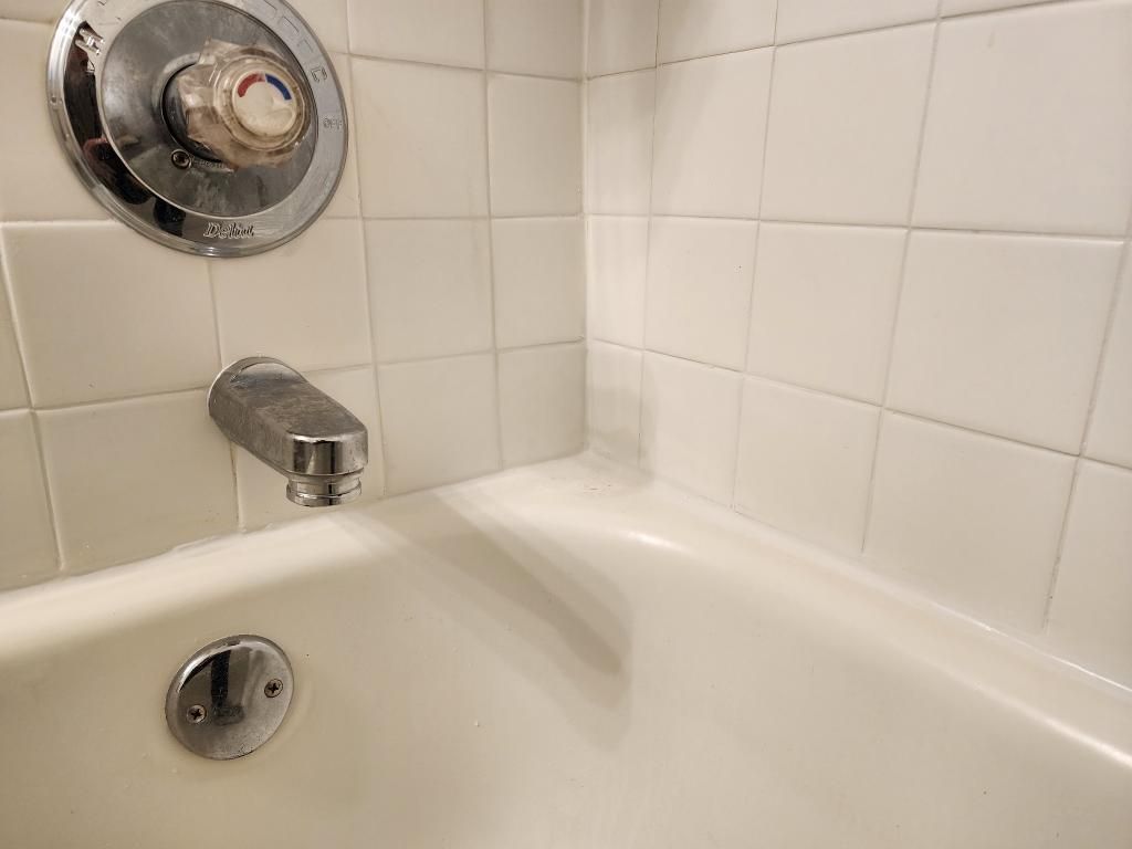 Tub surround after cleaning, new grout and color-sealed grout lines